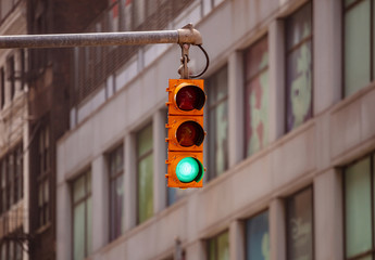 Green traffic lights for cars, blur office buildings background