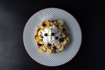 Belgian waffles with chocolate cream, bananas, oranges, blueberry, nuts and whipped cream