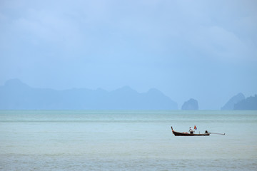 KRABI,THAILAND-AUGUST 18, 2018 : Lifestyle of local fisherman,the fisherman is standing on his small fishing boat and doing something about his occupation in a sea