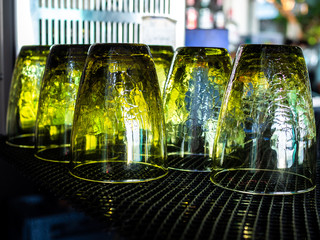 Vintage yellow glasses upside down on black table