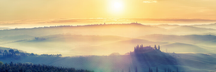 Beautiful foggy tuscany landscape at sunrise