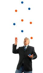 Man juggling a lot of balls in the air representing being busy in life and business with several...