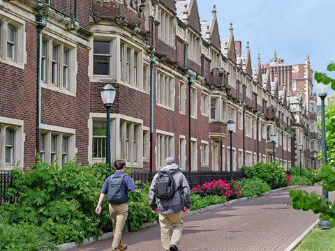 Brick Student Residence Building With Gothic Stylistic Elements, Such As Bay Windows And Stone Frames Around Windows