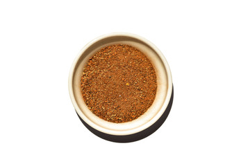 Saucer dish with ground cinnamon isolated on white background