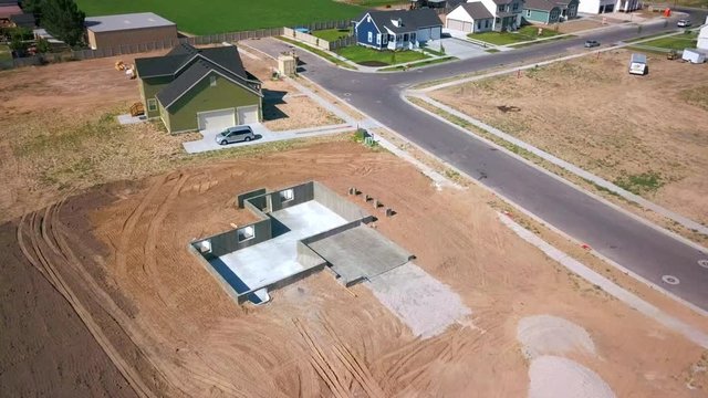 A drone shot spinning around a foundation and basement walls that had just been poured.