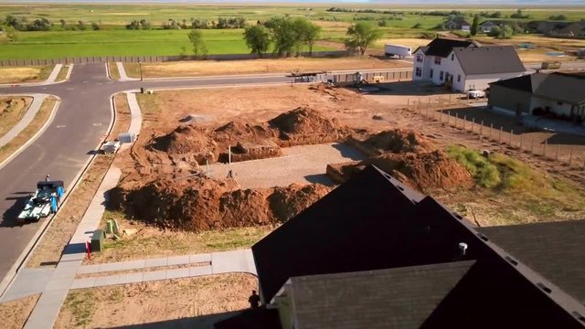 A drone shot spinning around a recently dug hole for the starting of a new house about to built.