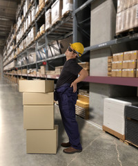 Worker with holding parcel boxes having a backache