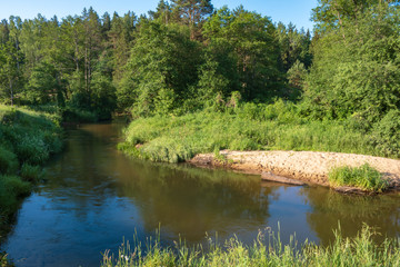 Fototapeta na wymiar Photo of the river in the evening hour of nature in the summer on a sunny day. Beautiful dawn time.