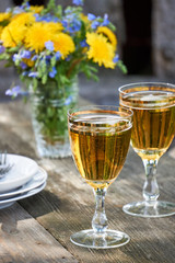Two glasses of fresh light beer on a wooden table