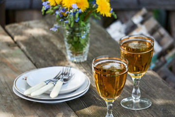 Two glasses of fresh light beer on a wooden table