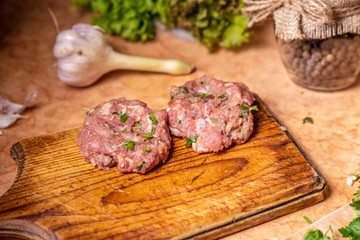Homemade raw two cutlets on the board.