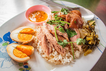 Stewed pork leg on rice, Thai street food.