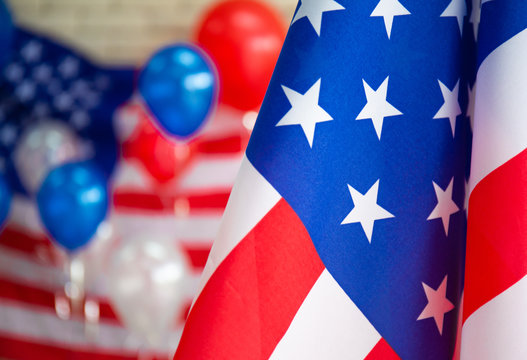 The national flag and celebration on Independence Day (or the 4th of July), American flag close up front blur red white and blue balloon background. - Image