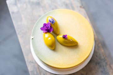 Mousse dessert covered with yellow velour. Modern european cake. Sweet dessert and tea party....