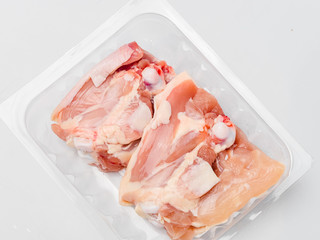 Chicken thighs in plastic pack from supermarket, ready to cook.
