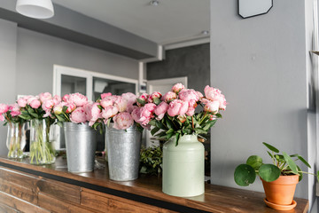 The counter of the flower shop. Pink peonies in a metal vase. Beautiful peony flower for catalog or online store. Floral shop concept . Beautiful fresh cut bouquet. Flowers delivery