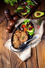 Pork steak with mushrooms and buckwheat groats and mango salad