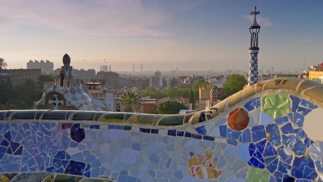 Steadicam shot of Park G&uuml;ell and city of Barcelona, Spain. Bright colored mosaic is seen in the foreground. UHD