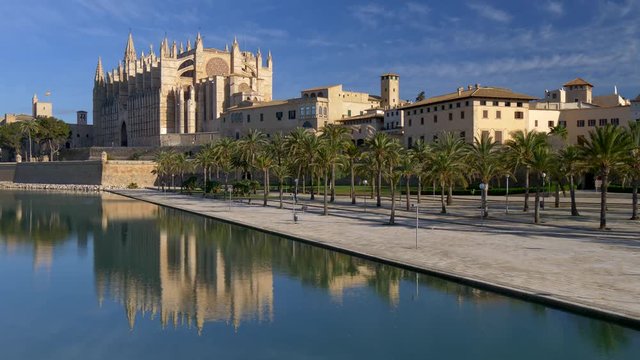 Palma Cathedral (or the Cathedral of Santa Maria of Palma, La Seu) in Palma, Mallorca (Majorca). The cathedral is built in Gothic style. The cathedral is reflected in water. UHD