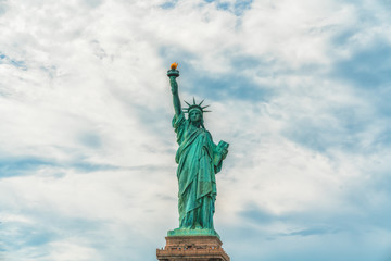 Fototapeta premium Statue Of Liberty, New York City Against Cloudy Blue Sky Background. Copy Space, Patriotism, Happy Forth of July, Independence Day, Travel Contest
