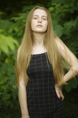 beautiful young blonde with long flowing hair on a blurry background