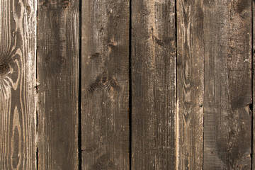 An old wooden blackened bulletin board after the rain, the wall of the boards.