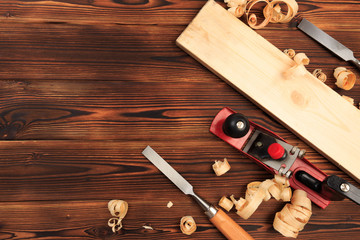 chisels plane and sawdust on a wooden table.
