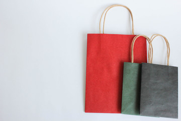  red, green, black paper shopping bag with handles on a white background