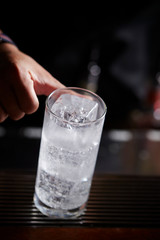 Making drink at bar, soda water in glass 