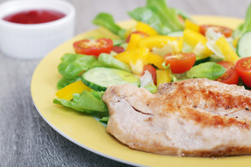 Grilled chicken breast with raw vegetables salad	