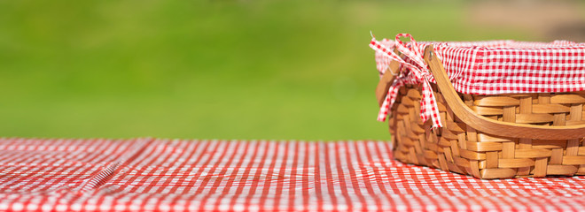 picnic basket on a table with a red tablecloth. Summer mood. relaxation. holidays