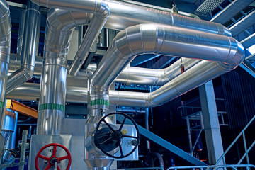 Equipment, cables and piping as found inside of a modern industrial power plant