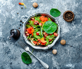 Salad with vegetables, nuts and nasturtium - obrazy, fototapety, plakaty