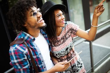 Travel, tourism, summer vacation, technology and friendship concept - smiling couple with tablet pc