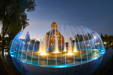 fountain in front of the church at night