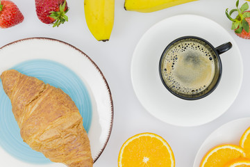 Breakfast with croissants and fruits