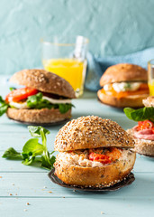 Sandwiche with crab salad and shrimp, multigrain bun on blue wooden background. Healthy lunch concept with copy space