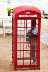 Old-fashioned traditional red public telephone booth