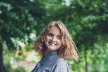 Happy attractive blond woman looking back