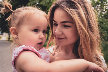 Loving mother holding her baby daughter