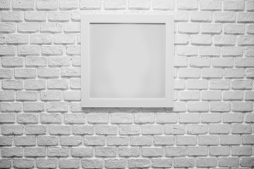 blank paper frames on white brick wall