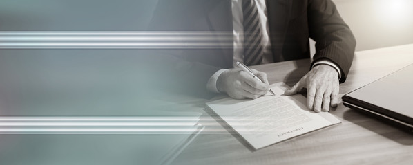 Businessman signing a document (lorem ipsum text used)