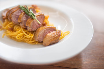 Pasta with meat on wooden table
