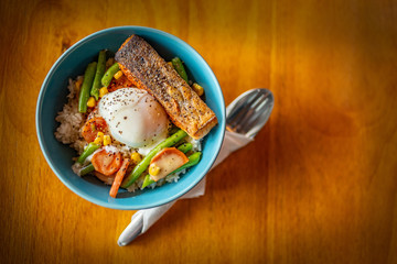 a bowl rice food on the wooden table

