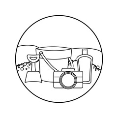 bucket with camera and bottle of blocker in beach