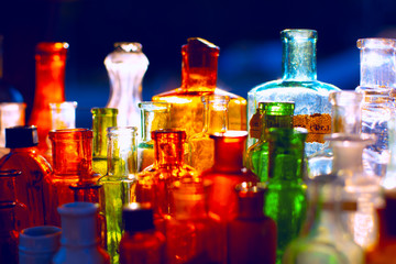 Colored glass bottles under light