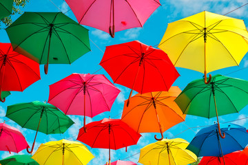 Fototapeta na wymiar Colorful umbrellas in the sky as background. Street decoration.