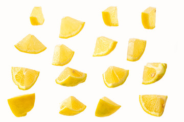 slices of sliced lemon isolated on a white background in a chaotic manner .