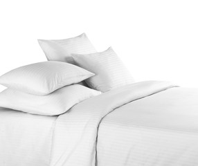 White bedlinen on a white bed isolated. Bedroom with bed and linen. Bed with pillows and duvet isolated.
