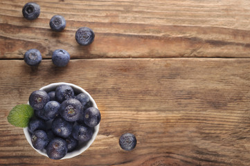 Fresh organic blueberries on wooden background.